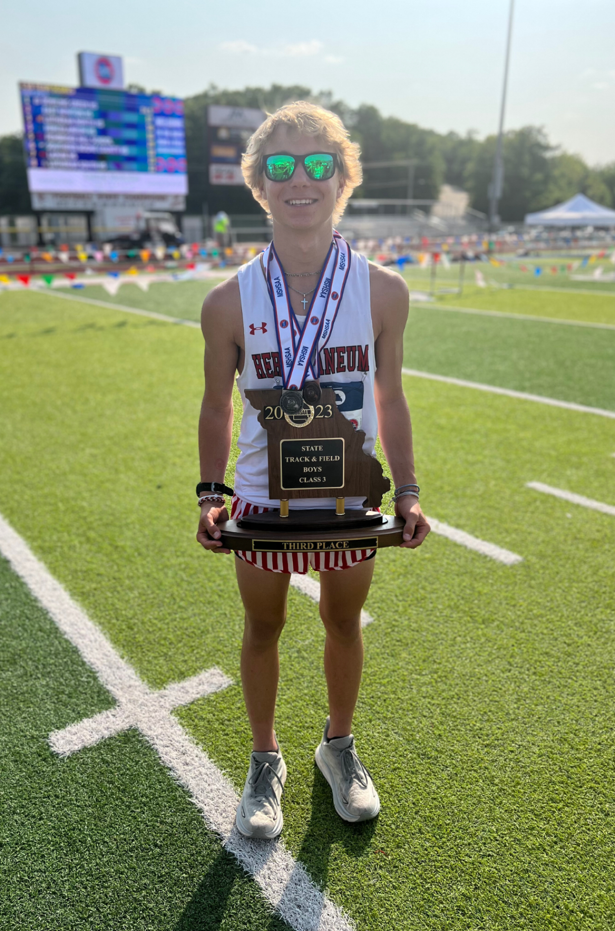 Sam holding a state track trophy