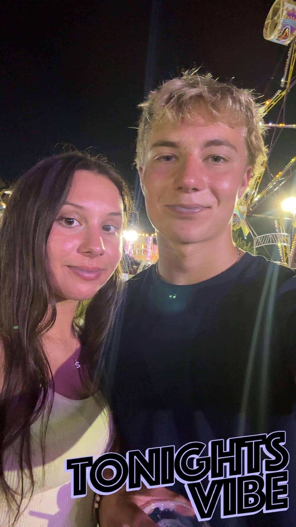 Sam and his girlfriend at a fair